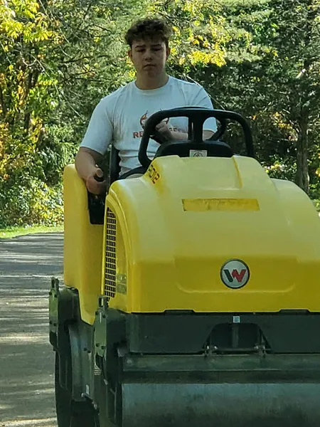 Tony's son operating the law roller.